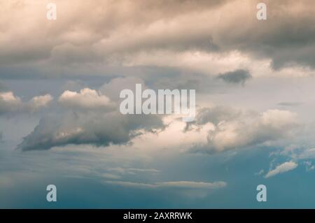 Background of sunset with clouds. Cloudscape under cinematic color filter. Stock Photo