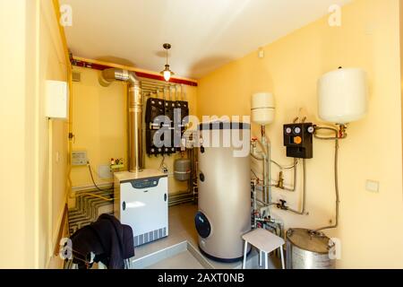 Boiler room and heating system in the cottage. Gas and electric boilers,  voltage stabilization system. Hot water is distributed through the house  heat Stock Photo - Alamy