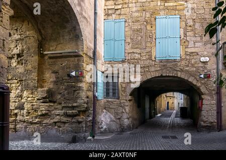 Stone arches in Pézenas. Historical old city. Built around the XVI century. Stock Photo