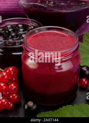 Closeup black and red currant jam in glass Stock Photo