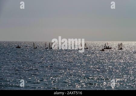 Small boats, yachts, sailing on a silver sea off the Spanish coast at Vilajoyosa, Costa Blanca, Spain Stock Photo