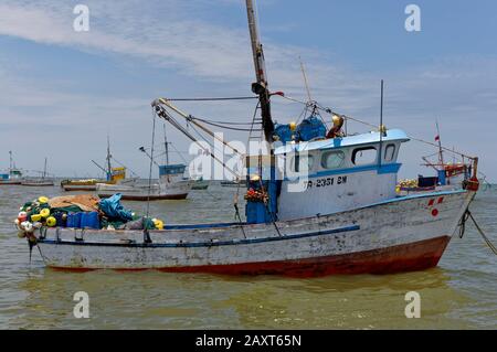 A traditional Peruvian Wooden Inshore Fishing Boat anchored off the coast near to Mancora. Stock Photo