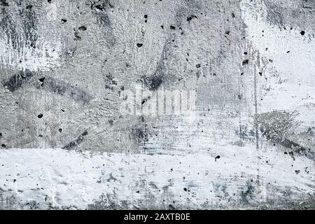 Spotted grey concrete wall, gray urban background, old grunge monochrome texture. White painted surface of stone with stucco. Architecture rough backd Stock Photo