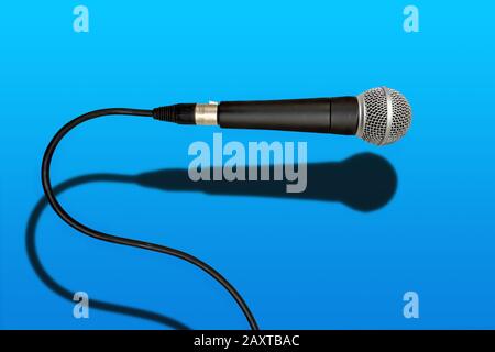 wired singer black and grey microphone on red lava color background Stock Photo