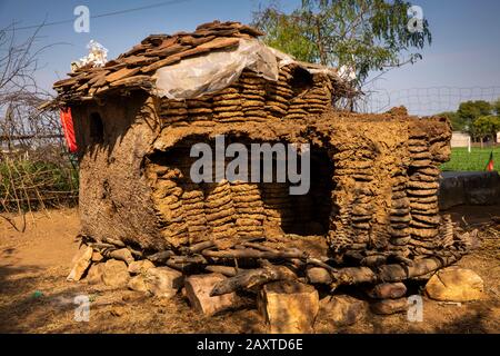 India, Rajasthan, Ranthambhore, Khilchipur, traditional cow dung fuel cakes stacked against rainy weather Stock Photo