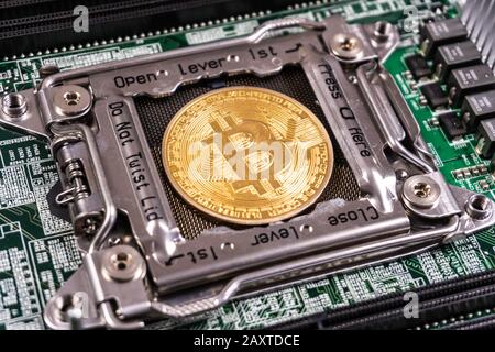 Golden Bitcoin Cryptocurrency on computer circuit board. Blockchain and security concept Stock Photo