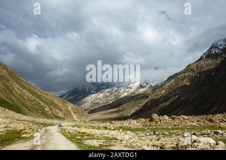 A jeep travelling on mountain roads coming from the mountains Stock Photo