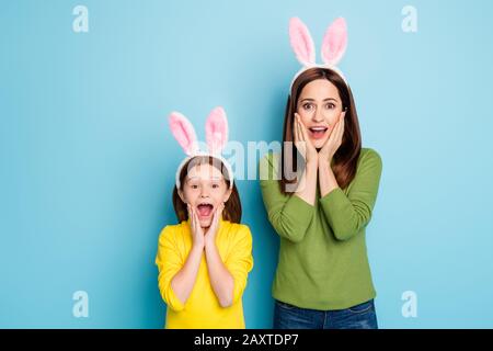 Portrait of nice attractive lovely charming pretty amazed cheerful cheery girls wearing rabbit ears having fun isolated over bright vivid shine Stock Photo