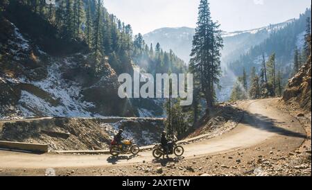 Two motorcyclists halted on a mountain road Stock Photo