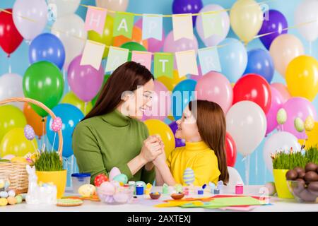 Portrait of nice attractive lovely sweet tender cheerful cheery girls preparing craftwork handmade holding hands spending day small little offspring Stock Photo