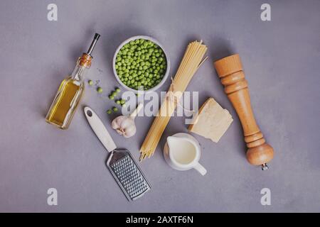 Raw ingredients for making spaghetti with fresh peas Stock Photo