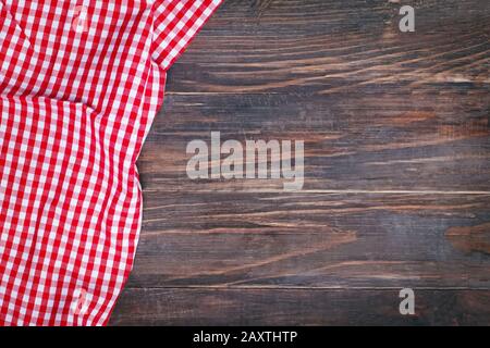 Red checkered napkin on a rustic wooden table with copy space Stock Photo