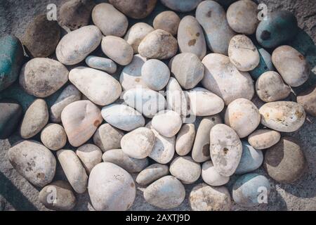 White pebbles with smooth surface on the surface top view Stock Photo