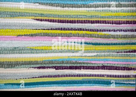 Close up of beautiful colorful motley rug or carpet. Structure of fabric. Bright colored strips Stock Photo