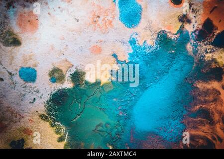 Multicolored paint stains, drips, splashes, mixing. Abstract background Stock Photo