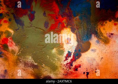 Multicolored paint stains, drips, splashes, mixing. Abstract background Stock Photo