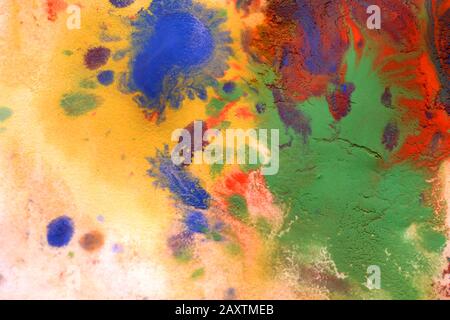 Mixing of paints of different colors on a white paper. Abstract colorful background, base Stock Photo