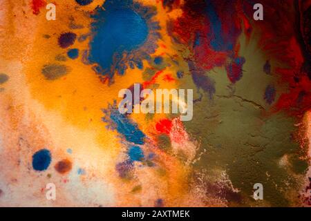 Multicolored paint stains, drips, splashes, mixing. Abstract background Stock Photo