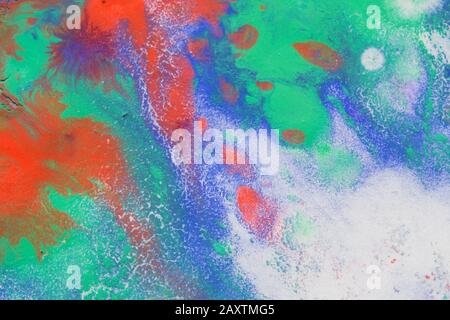 Multicolored paint stains, drips, splashes, mixing. Abstract background Stock Photo