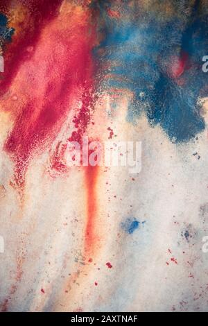 Mixing of paints of different colors on a white paper. Abstract colorful background, base Stock Photo