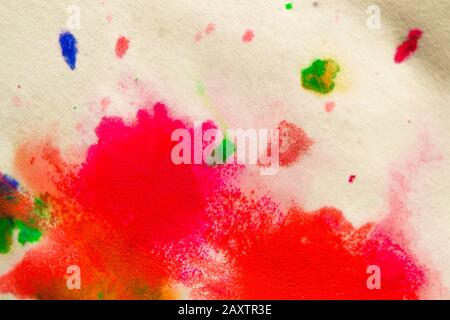 abstract spots splash of bright red, green, blue colors on white paper macro Stock Photo