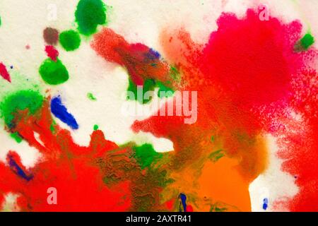abstract spots splash of bright red, green, blue colors on white paper macro Stock Photo
