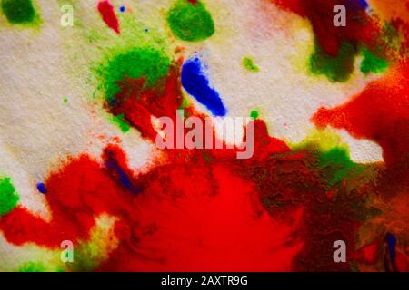 abstract spots splash of bright red, green, blue colors on white paper macro Stock Photo