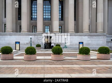 Washington, DC, USA -- February 3, 2020. Two guards at an entrance to the National Archives building on Constitution Avenue in Washington DC. Stock Photo