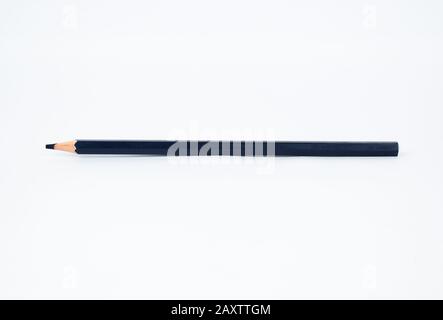 A deep navy blue colored sharp wood pencil crayon isolated on a clear white background Stock Photo