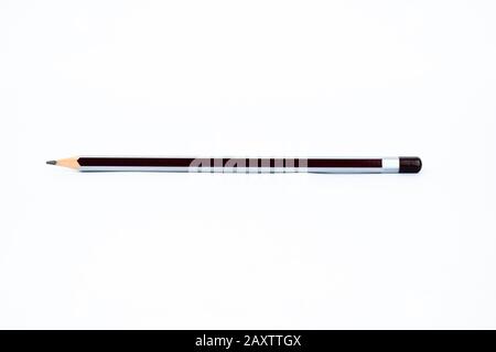 A silver and black colored sharp wood pencil is displayed on an isolated white background Stock Photo