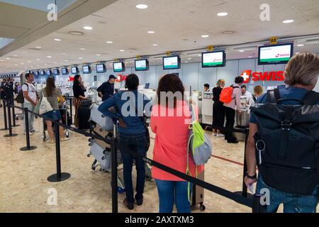 Swiss passengers in queue / queuing / queues / waiting area to check in their case, luggage, suitcases / suit suitcase and hand luggage. Airport, Switzerland. (112) Stock Photo