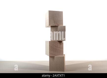 tower of four wooden blocks on table against white background template Stock Photo