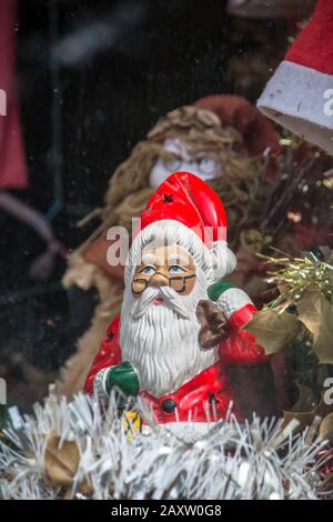 View of old ceramic Santa Claus doll, in decoration shop window... Stock Photo