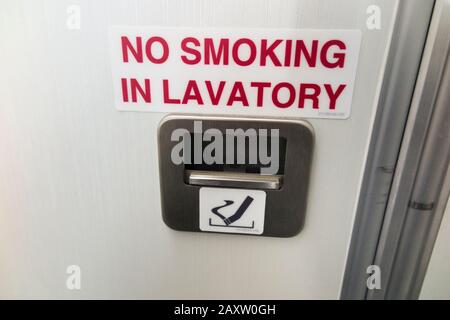 Ash tray / ashtray and No Smoking sign in toilet / loo / lavatory / WC in a Bombardier C series plane / aeroplane / airplane (An aircraft now marketed UK as an Airbus A220). (112) Stock Photo