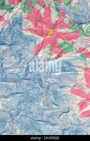 pink flowers painted paints on a crumpled blue paper Stock Photo