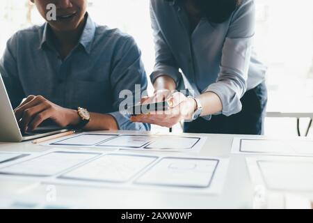 Programmer and UX UI designer working in a software development and coding technologies. Mobile and website design and programing development technolo Stock Photo