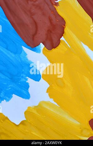 abstract background brush strokes yellow, brown, blue ink on white paper close-up Stock Photo
