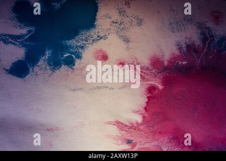 pink and blue flowed blots on white paper Stock Photo