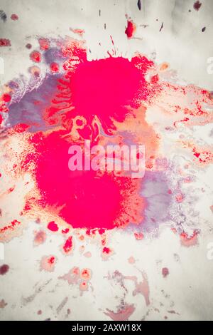 Abstract background of blots pink, red and maroon color with streaks and splashes on white paper Stock Photo