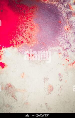 Abstract background of blots pink, red and maroon color with streaks and splashes on white paper Stock Photo