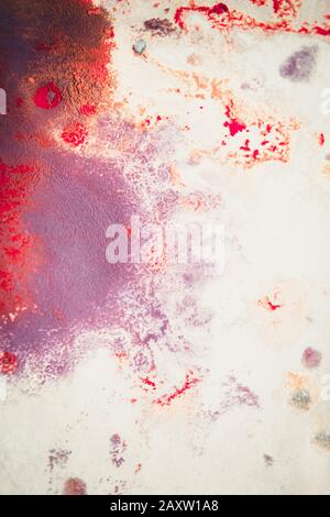 Abstract background of blots pink, red and maroon color with streaks and splashes on white paper Stock Photo