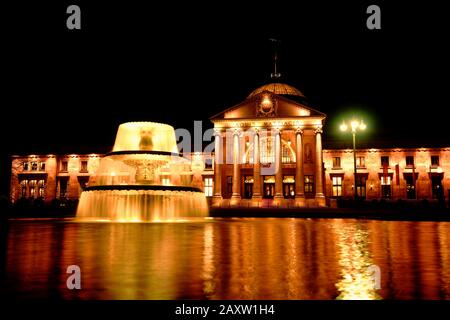 Wiesbaden Germany Kurhaus spa house casino and fountain illuminated at night. Golden night scene. Stock Photo