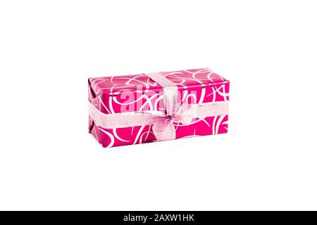 packaged rectangular gift in pink packaging with gold bow and gold pattern on a white background Stock Photo