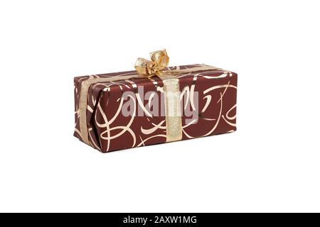 packaged rectangular gift in dark brown packaging with gold bow and gold pattern on a white background Stock Photo
