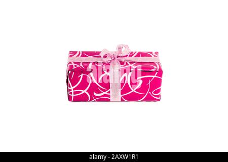 packaged rectangular gift in pink packaging with gold bow and gold pattern on a white background Stock Photo