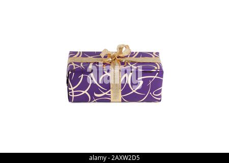 packaged rectangular gift in purple packaging with gold bow and gold pattern on a white background Stock Photo