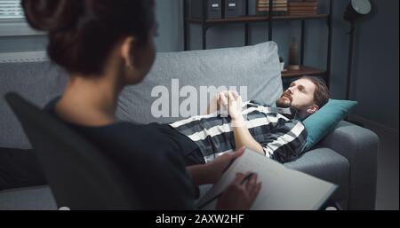Lying man talking with psych Stock Photo