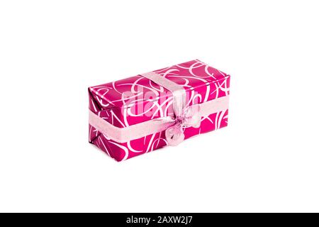 packaged rectangular gift in pink packaging with gold bow and gold pattern on a white background Stock Photo