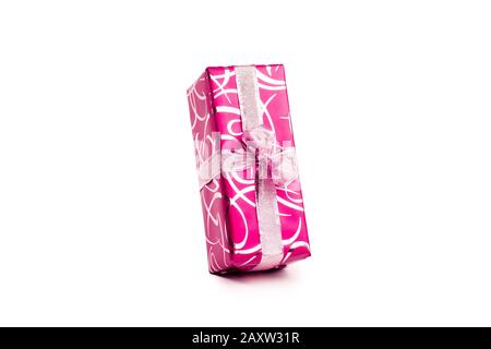 packaged rectangular gift in pink packaging with gold bow and gold pattern on a white background Stock Photo