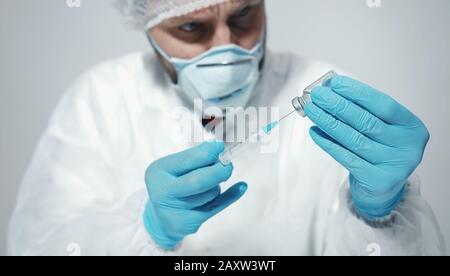 Male doctor preparing syringe